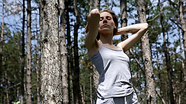 Brunette Cherry Kiss enjoys her body in the forest