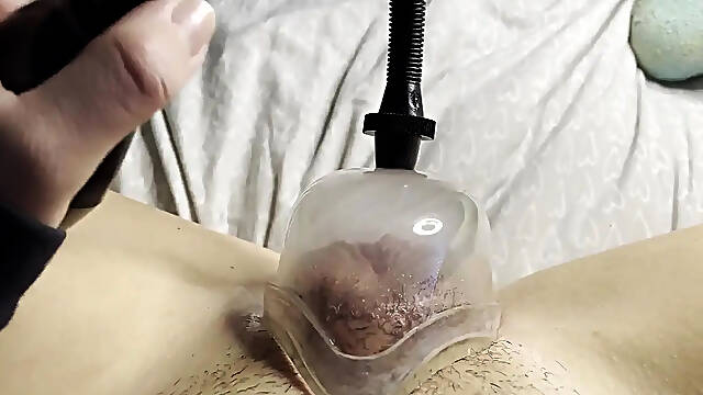 Sultry solo close-up of big clit pumping with a pussy pump