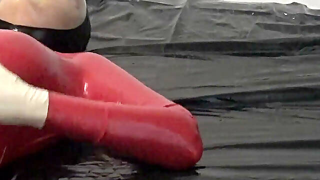Photoshooting in Red Latex Catsuit with Latex Mask and Transparent Face.